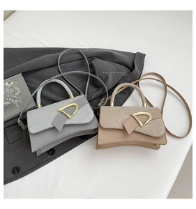 Detail of silver and beige crossbody bags with metallic glitter stitching and D-buckle