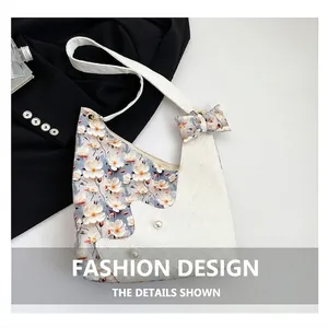 Close-up of tulip tote bag with floral patterns, pearl beads, and bow detailing