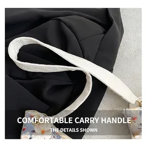 Detail of white braided strap with gold hardware on floral print shoulder bag