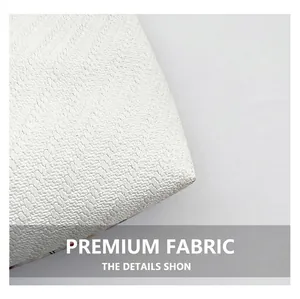 Close-up of the premium white textured waffle weave fabric showing intricate fiber details