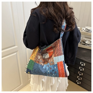 Bohemian patchwork denim bag with geometric patterns and fashion label shown on model