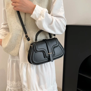 Structured black faux leather crossbody bag with top handle and gold metal detail