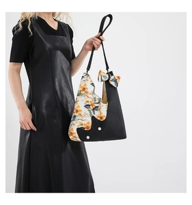 Artistic nylon tote with floral print, pearl accents and bow detail on model