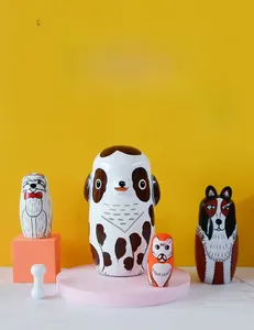 Detailed close-up of colorful hand-painted wooden nesting dolls featuring dog designs
