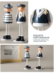 Detailed close-up of hand-painted wooden nautical dolls with navy stripes and hats