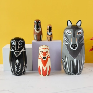 Five-piece wolf and fox theme wooden nesting dolls on a vibrant yellow background