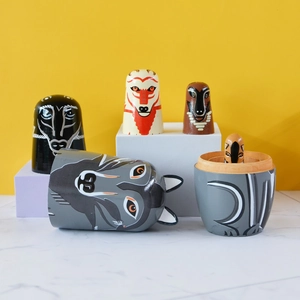 Modern painted wooden Russian nesting dolls featuring wolf and fox animal motifs