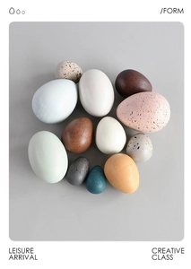 Top view of creative painted wooden decorative eggs in neutral tones with speckled details