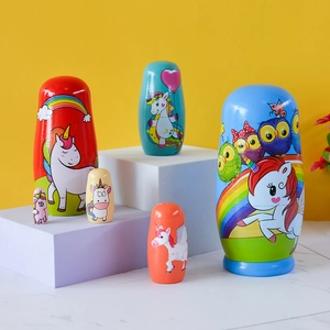 Hand-painted wooden unicorn nesting dolls set with rainbow and owl patterns for children