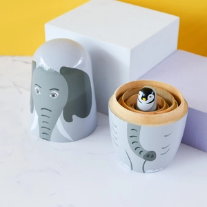 Handcrafted wooden nesting dolls featuring gray elephant and penguin animal designs