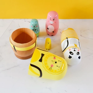 Handcrafted wooden Russian matryoshka dolls featuring vibrant painted cartoon animal designs