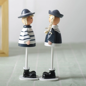 Handcrafted wooden nautical sailor dolls with blue stripes and hanging legs for home decor