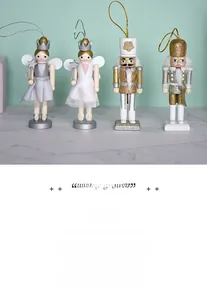 Detail of wooden nutcracker fairy and soldier figures with silver glitter and paint