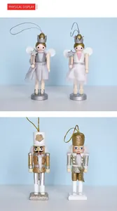 Close-up of wooden nutcracker fairy and soldier hanging ornaments with glitter and tulle
