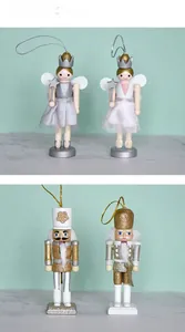 Close-up of wooden nutcracker fairy and soldier hanging ornaments with glitter and tulle