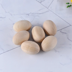 Set of 6 natural wooden eggs for DIY crafts and home decor on white marble background