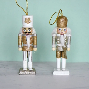 Set of two white and gold wooden nutcracker ornaments with glitter for Christmas tree decor