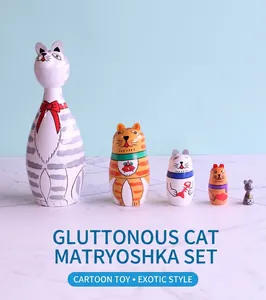 Detailed view of five handcrafted wooden nesting dolls with colorful cartoon cat patterns