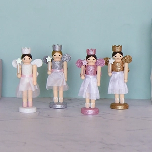Set of four wooden nutcracker fairy ornaments with crowns and glitter for Christmas