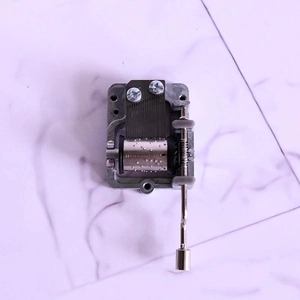 Mechanical hand-crank music box movement made of metal with vintage style design