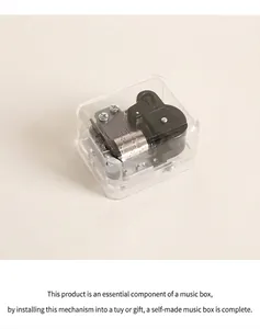 Macro view of clear plastic music box with precision silver mechanical clockwork mechanism