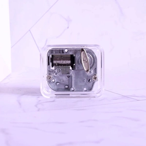 Clear acrylic music box with silver mechanical movement and top winding knob