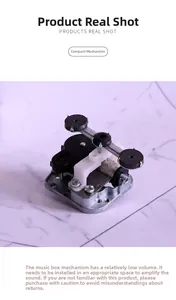 Mechanical music box movement detail showing spring mechanism and internal metal gear structure