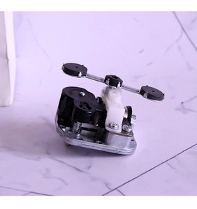 Mechanical music box movement with rotating balancer and gear mechanism parts