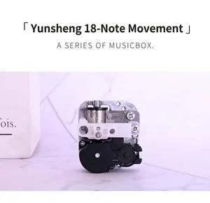 Detailed view of an 18-note mechanical music box movement with a rotating metal drum