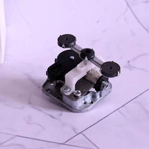 Macro view of precision mechanical music box movement with silver base and black gears