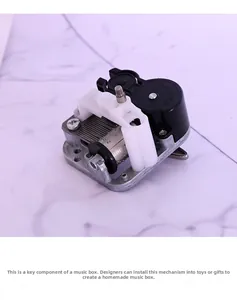Mechanical music box movement with silver metal cylinder and precision gears for DIY crafts