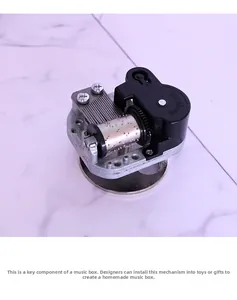 Close-up of mechanical clockwork music box movement with silver metal and black components