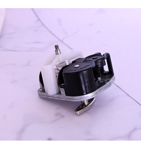 Detailed top view of a mechanical music box movement with gears and winding key