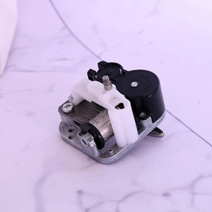 Macro detail of the mechanical wind-up music box movement with gears and drum