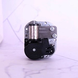 Macro view of mechanical music box movement with silver cylinder and steel comb