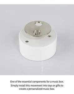Macro view of white plastic mechanical music box movement with silver metal rotating disk