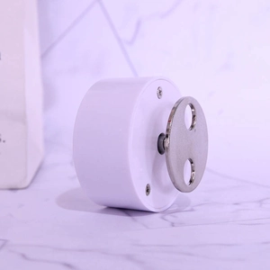 Mechanical wind-up music box movement with white plastic case and metal rotating handle