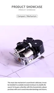 Mechanisches Spieluhrwerk mit silberner Metalltrommel und schwarzem Getriebegehäuse