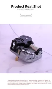 Detail of mechanical 18-note music box movement with gears and cylinder on marble surface