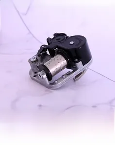 Close-up of DIY mechanical music box movement with 18-note cylinder and zinc alloy gears