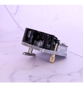 Mechanical 18-note music box movement mechanism with gold-tone gears and silver base
