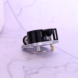 Mechanical 18-note DIY music box movement with winding key on marble background