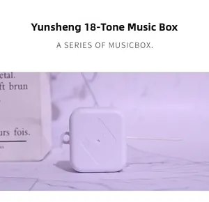 Macro detail of white plastic 18-note mechanical pull-string music box mechanism for DIY