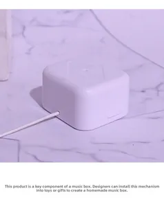 Detailed view of mini pull-string music box movement mechanism for DIY craft projects