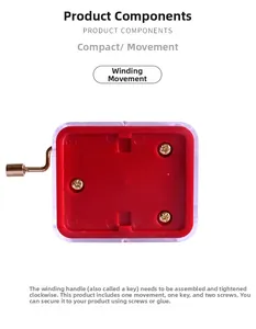 Macro detail of hand-crank music box movement with gold crank and red base in clear case