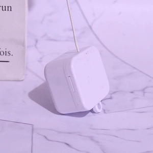 Detailed macro view of white square DIY mini musical pull-string movement mechanism