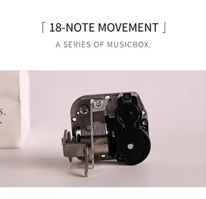Detailed macro view of 18-tone mechanical music box movement with stainless steel gears