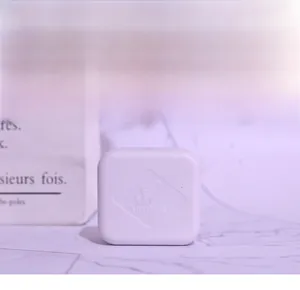 Detailed view of the white plastic music box movement case featuring an embossed Yunsheng logo