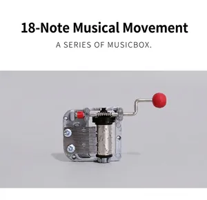 Close-up of 18-note hand-crank music box mechanism with metal cylinder and red handle