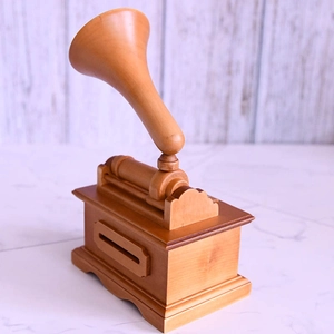 Detail of vintage wooden gramophone music box with hand-cranked DIY paper tape mechanism